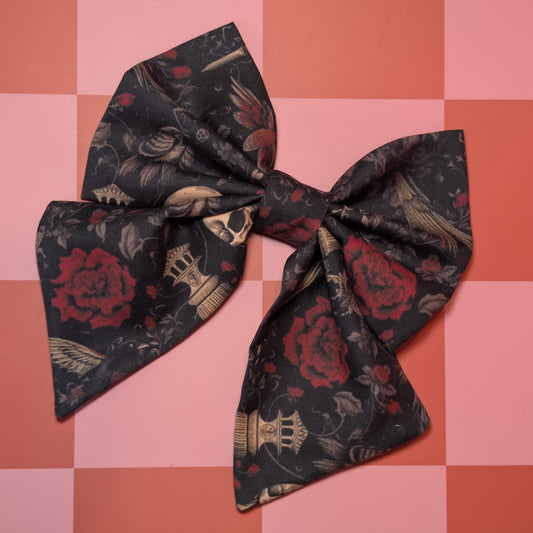 Floral patterned bow on a pink and orange checkered background