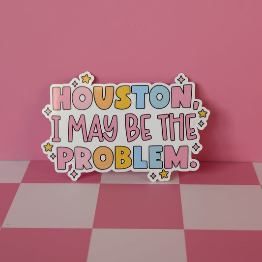 Colorful sticker with 'Houston, I may be the problem.' text on a pink checkered background