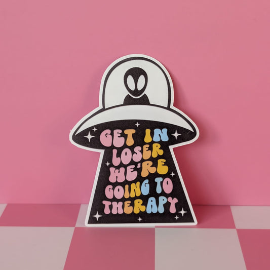 Sticker with text 'Get in loser, we're going to therapy' on a pink background