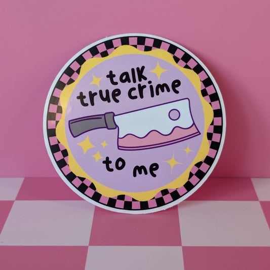 Circular sticker with 'talk true crime to me' text and knife graphic on a pink background