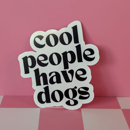 Sticker with 'cool people have dogs' text on a pink background