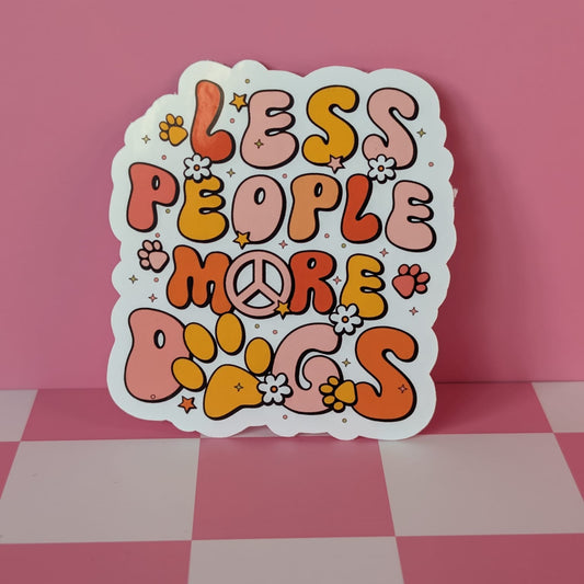 Colorful sticker with 'LESS PEOPLE MORE DOGS' text on a pink checkered background