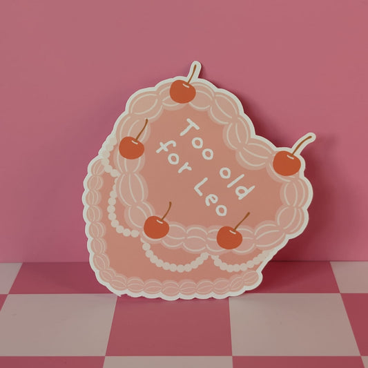 Decorative sign with 'Too old for Leo' text on a pink and white checkered surface