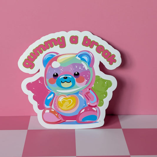 Colorful bear-shaped sticker with 'gummy a break' text on a pink checkered background